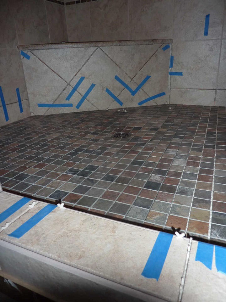 Tiles set over Kerdi shower floor